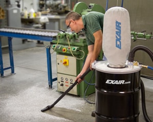 Exair - Industrial Housekeeping Worker using Exair drum vac to clean workshop floor